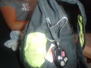 Car keys placed on a backpack using a shower curtain ring.