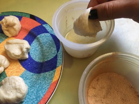 dipping dough piece in butter