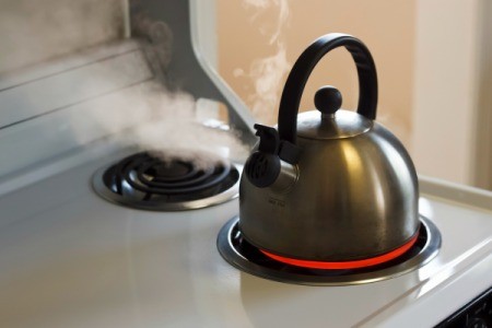 A tea kettle on a stove top.