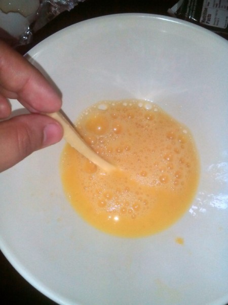 dipping cheese stick in egg