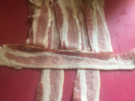 piece of bacon laid perpendicular to other strips