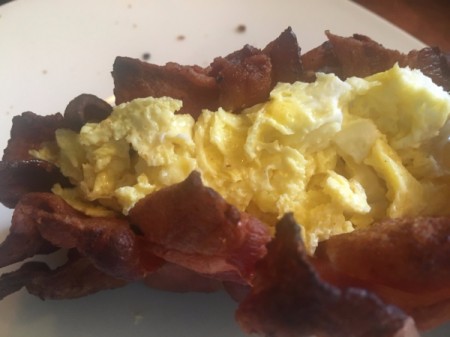 Woven Bacon Shell with egg and cheese added on plate