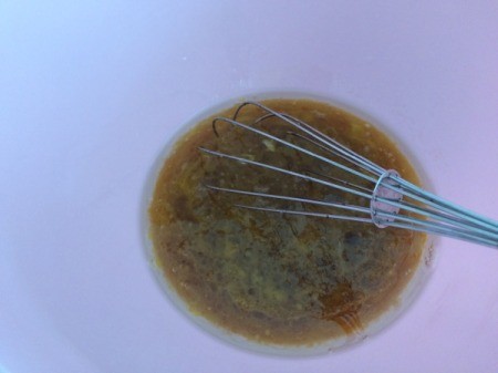 adding egg to oil and honey in bowl