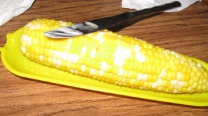 buttering corn in dish