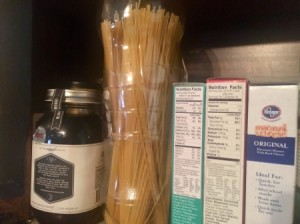 Spaghetti stored in 2-liter plastic soda bottles, in the pantry.