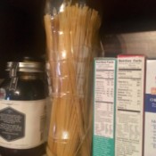 Spaghetti stored in 2-liter plastic soda bottles, in the pantry.