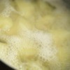 Potatoes boiling in water.
