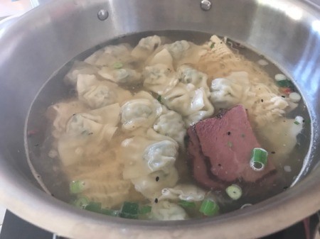 Wonton, ramen Noodles and ham in pot