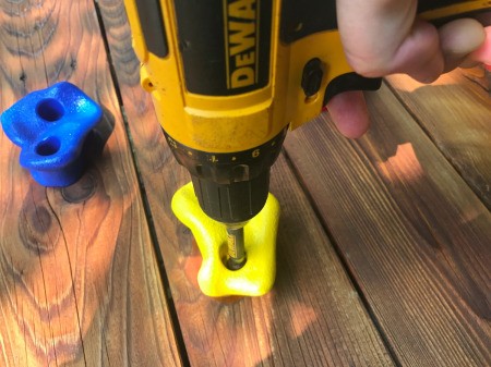 Refinishing a Wooden Playground - reassembling the climbing wall after the wood had been sanded and stained
