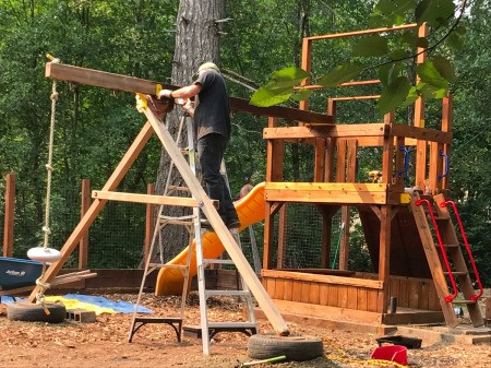 Refinishing a Wooden Playground - tires under the swing legs