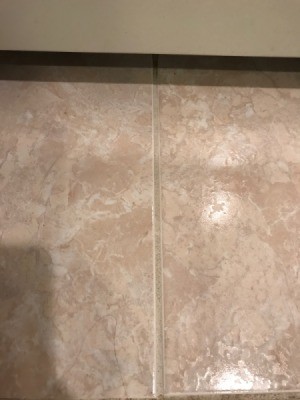 A clean grout line on a tiled floor.
