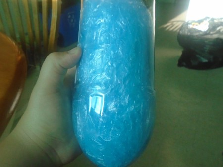 A collection of plastic bags stored in a pop bottle.