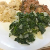 Sautéed Kale on plate with meat and potatoes