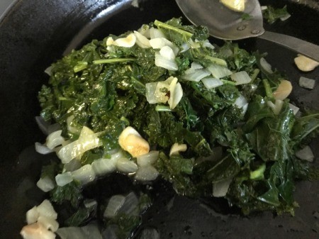 Sautéed Kale, garlic and onion in pan
