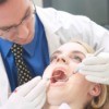 A woman being examined by a dentist.