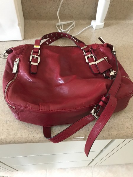 A red Michael Kors handbag found at a thrift store.