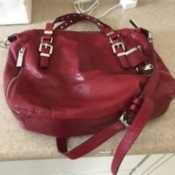 A red Michael Kors handbag found at a thrift store.
