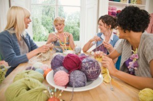 A group of friends knitting projects for charity.