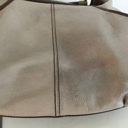 A leather bag that has been cleaned with a magic eraser.