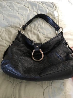 A new leather handbag that is slouchy and empty.