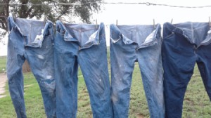 Use a Clothesline or Drying Rack - jeans hanging on a clothesline