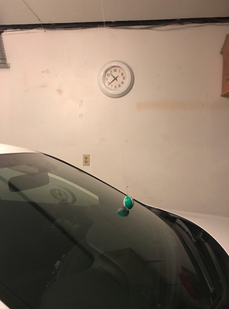 Using a tennis ball to mark how far to park in your garage.