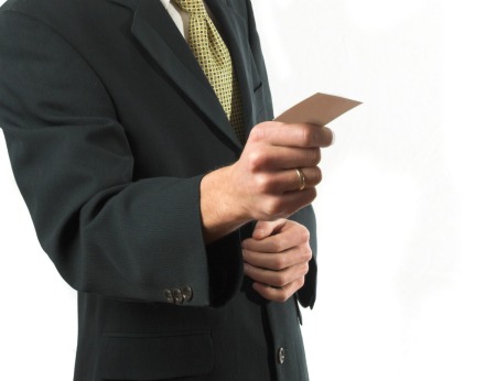 A man holding a business card.