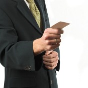 A man holding a business card.