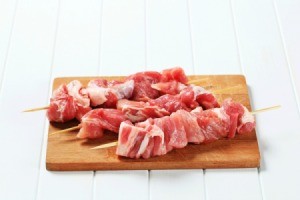 Raw pork on skewers.