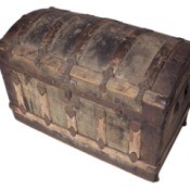 Photo of an old steamer trunk with a curved lid.