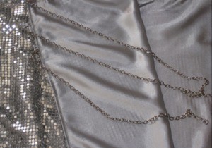 Chain straps on a metallic mesh dress.