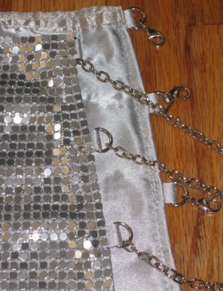 Chain straps on a metallic mesh dress.