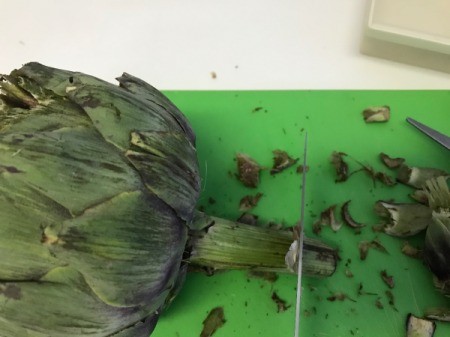 cutting end of artichoke stock