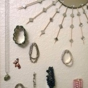 Jewelry being displayed using pushpins.