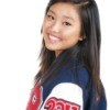 A teen female high school athlete wearing a letterman jacket.