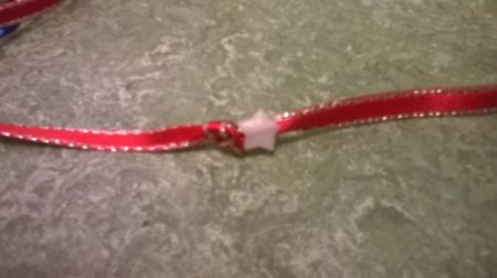 A bead added to a ribbon with a knot near the end.