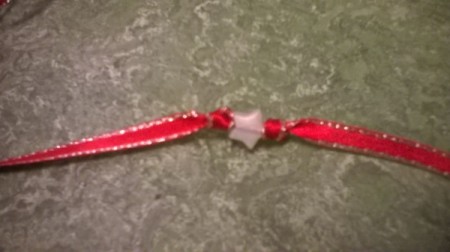 Another knot is tied after the bead and continue adding beads and knots.