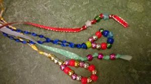 A collection of bead and ribbon bookmarks in different colors.