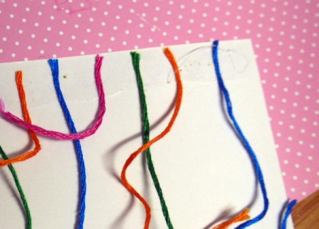 Hanging Baubles Greetings Card - run a line of glue along the top edge and glue down one end of each piece of floss