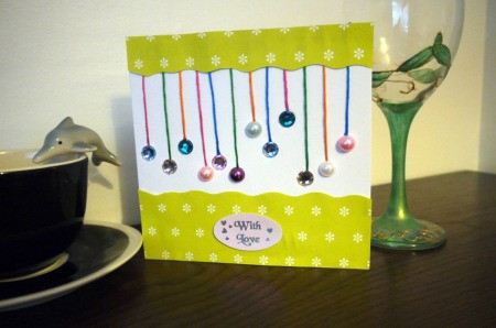 Hanging Baubles Greetings Card - finished card on table top