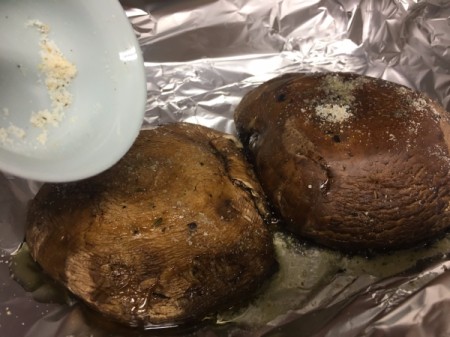 adding herbs to outside of Portobello Mushroom