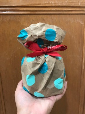 Make Your Own Gift Wrapping Paper - hand holding the wrapped gift