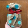 Make Your Own Gift Wrapping Paper - hand holding the wrapped gift