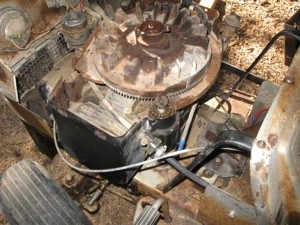 A lawn mower engine with the covering removed.