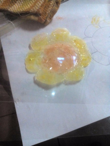 Glittered Glass Coaster Made from Hot Glue - cover with another piece of acetate or parchment paper