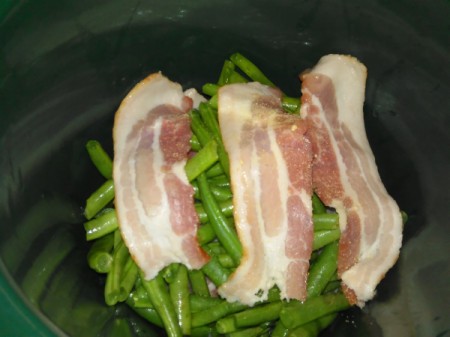 Bacon on layer of green beans