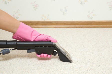 Using a carpet cleaner to remove odors from carpet.