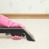 Using a carpet cleaner to remove odors from carpet.