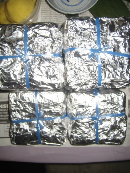 Vietnamese "Banh Chung" Sticky Rice Cakes wrapped with foil to cook