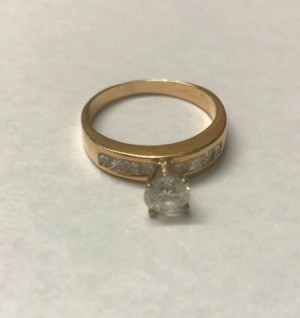 A shiny diamond and gold ring.